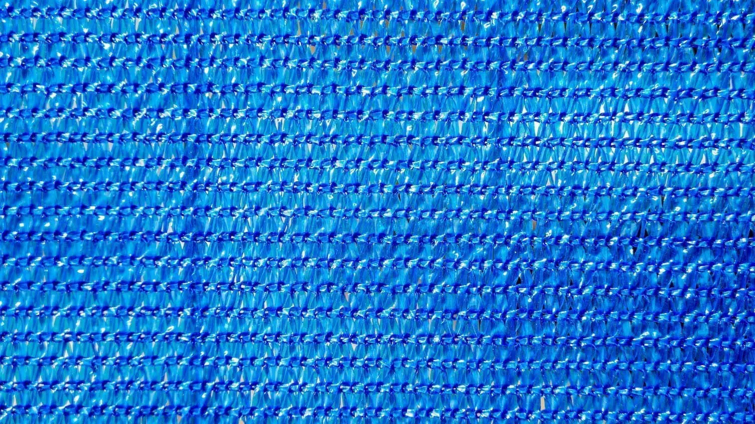 zoomed in view of blue material for a privacy fence