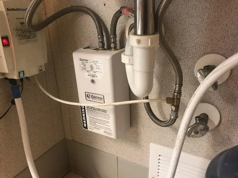 A close-up of the ambient water pump system with visible piping and electrical connections