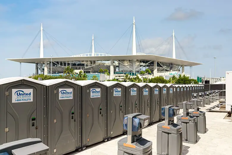 rows and rows of porta potties and hand washing stations outside an sport stadium