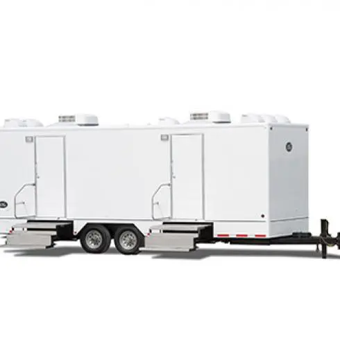 A white restroom trailer exterior on a plain background, featuring a hitch and wheels