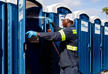 a man is cleaning the porta potties on the event site